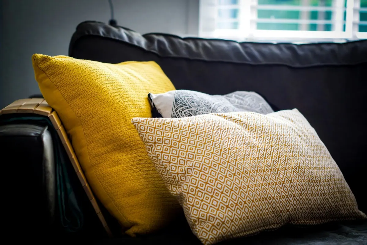 Soft furnishing textiles arranged with cushions and décor fabric samples