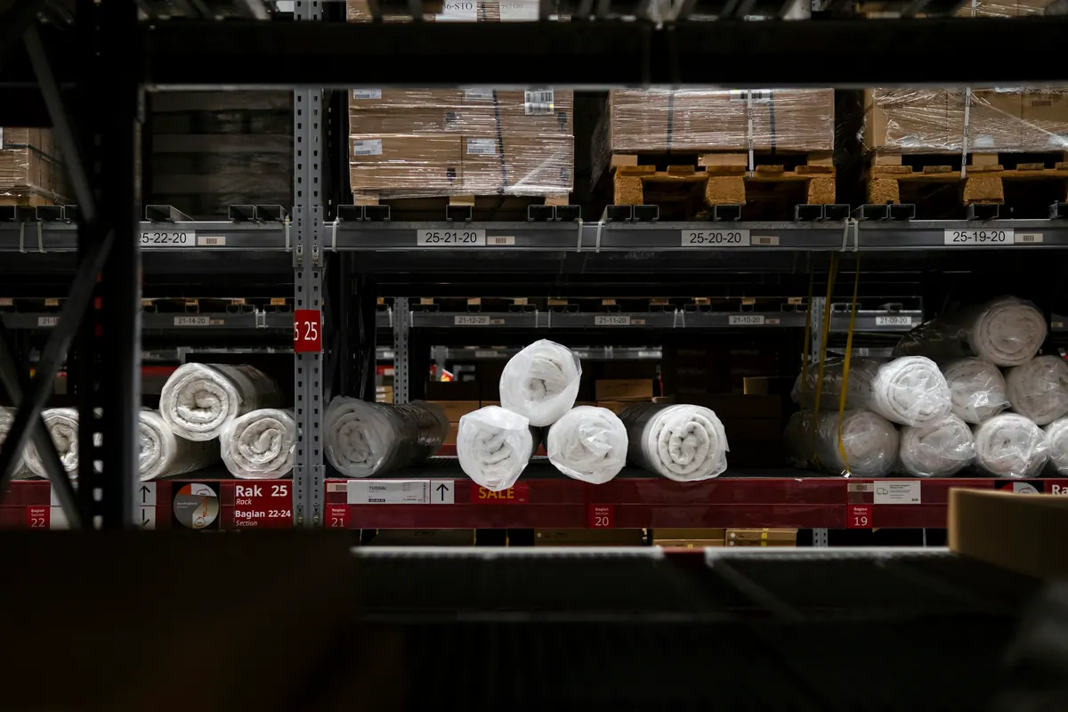 Rolls of wholesale textile material stacked for trade supply